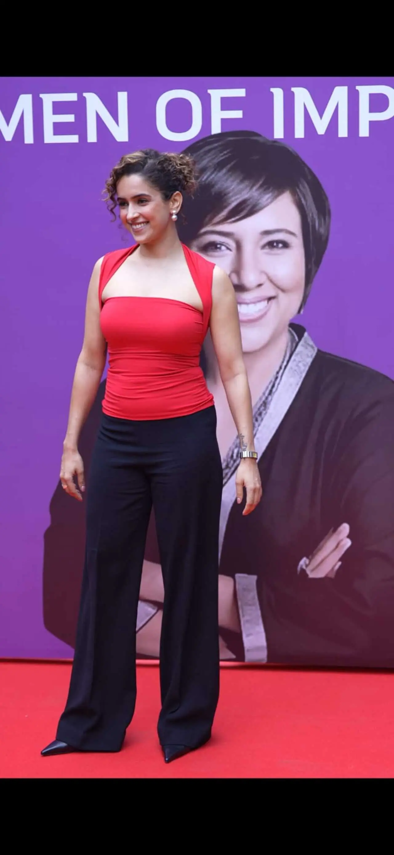 Sanya Malhotra stunned in a red sleeveless top paired with black pants. She flashed her bright smile as she posed for paps.